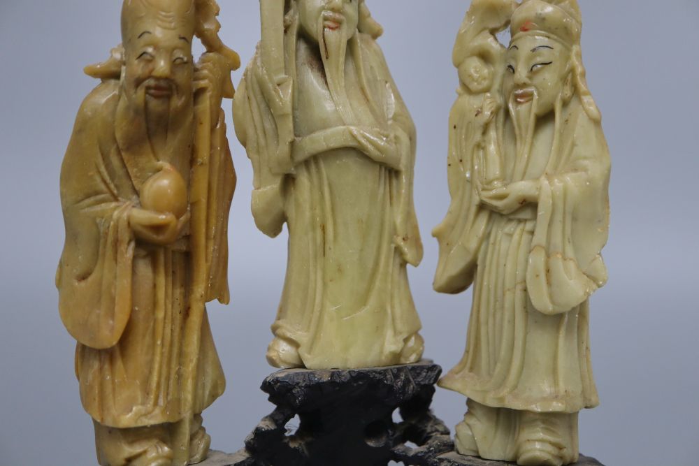 Three Chinese soapstone carvings of immortals, on base, height 19cm